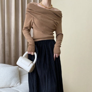 Women’s irregular style knit top with off-the-shoulder design.