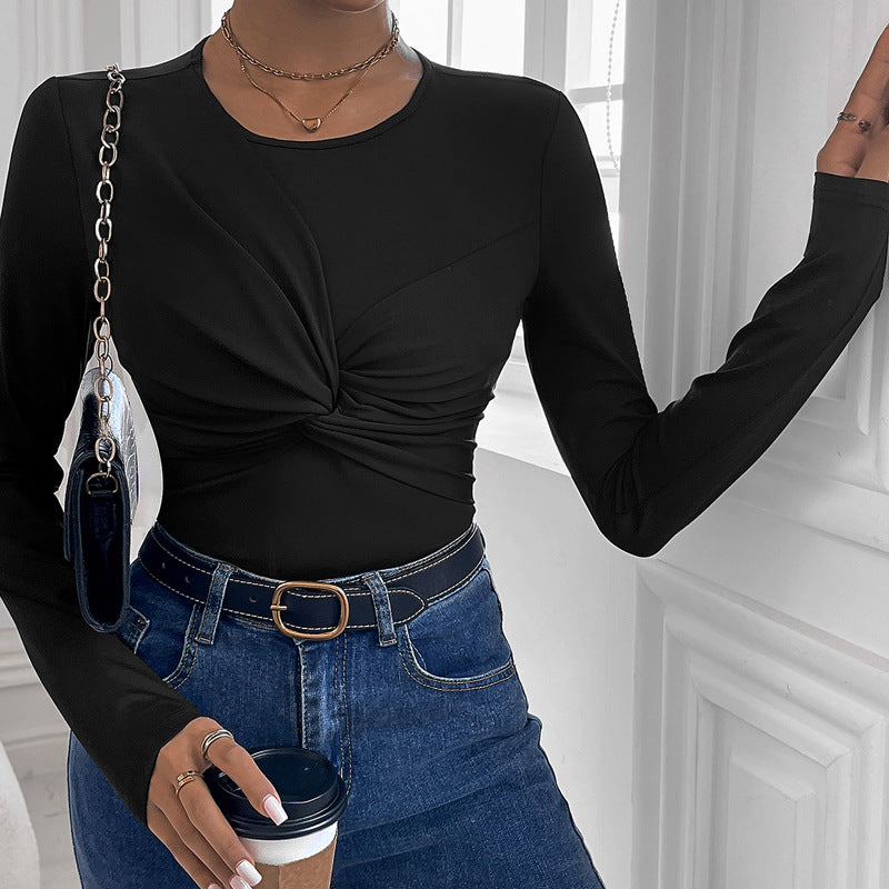 Solid black body with a twist collar and minimalist style.