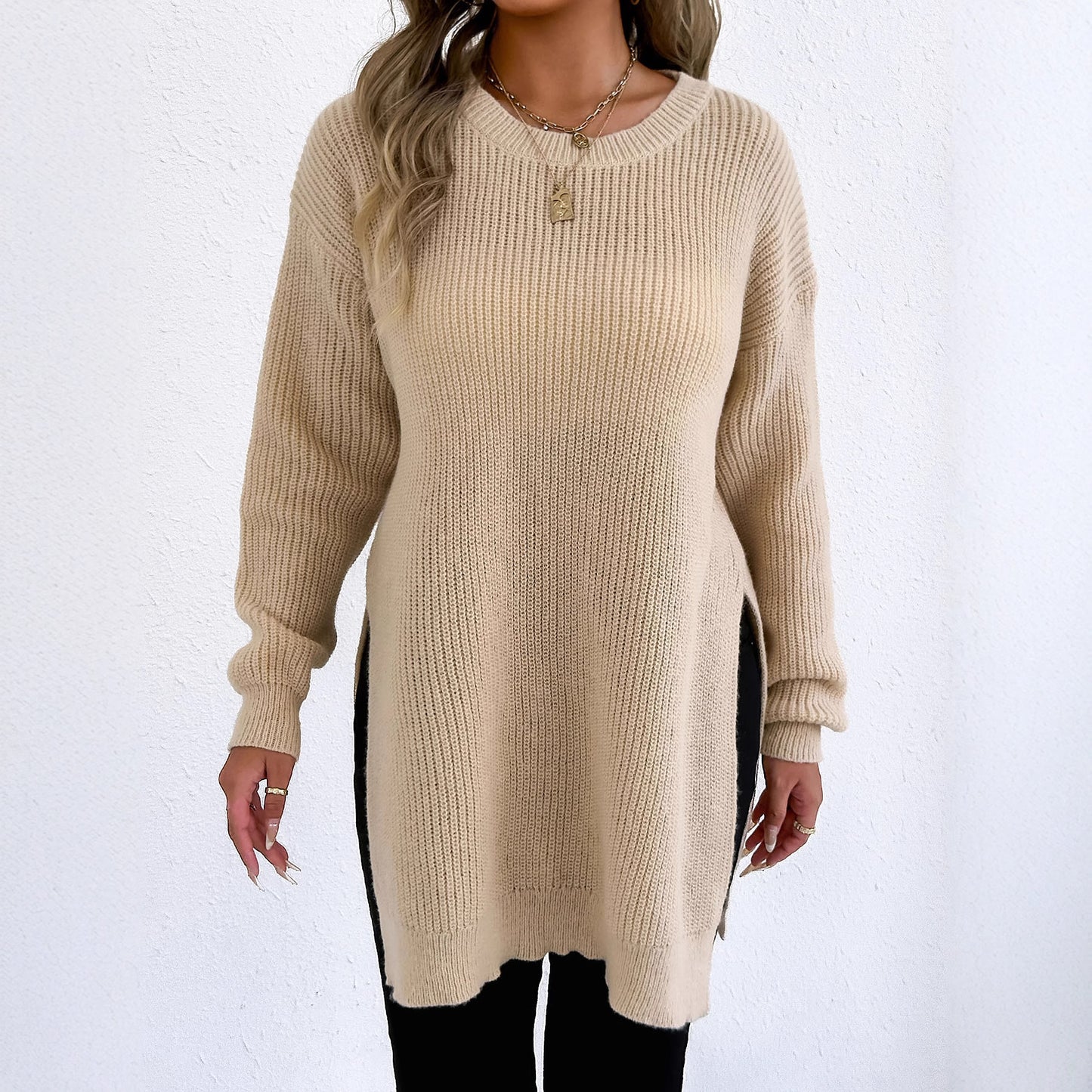 Casual crew-neck sweater with slit design and relaxed style.