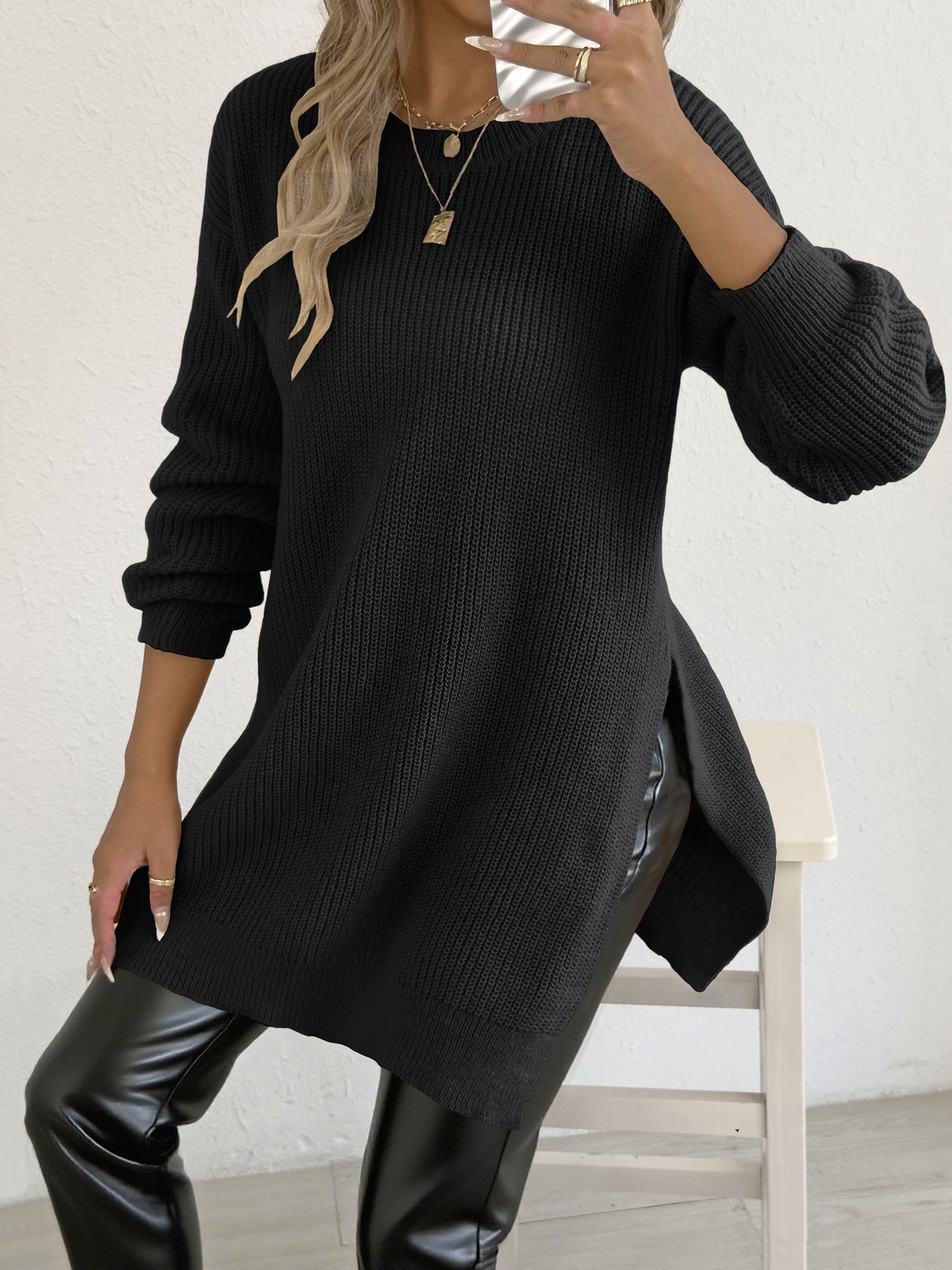 Casual crew-neck sweater with slit design and relaxed style.