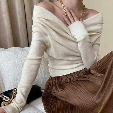 Women’s irregular style knit top with off-the-shoulder design.