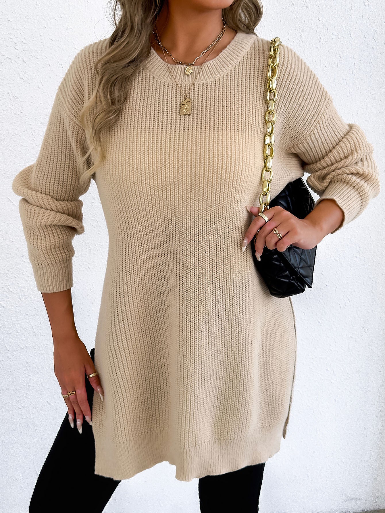 Casual crew-neck sweater with slit design and relaxed style.
